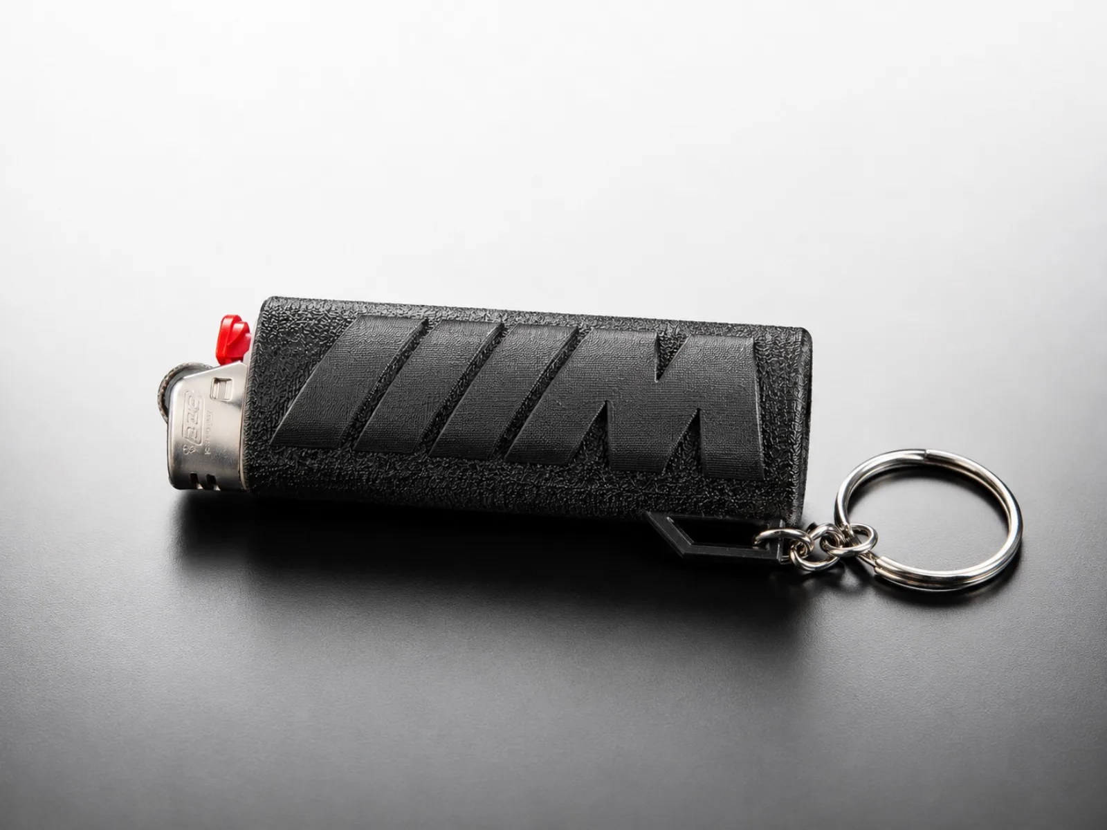 Black BMW M-style lighter case lying on its side