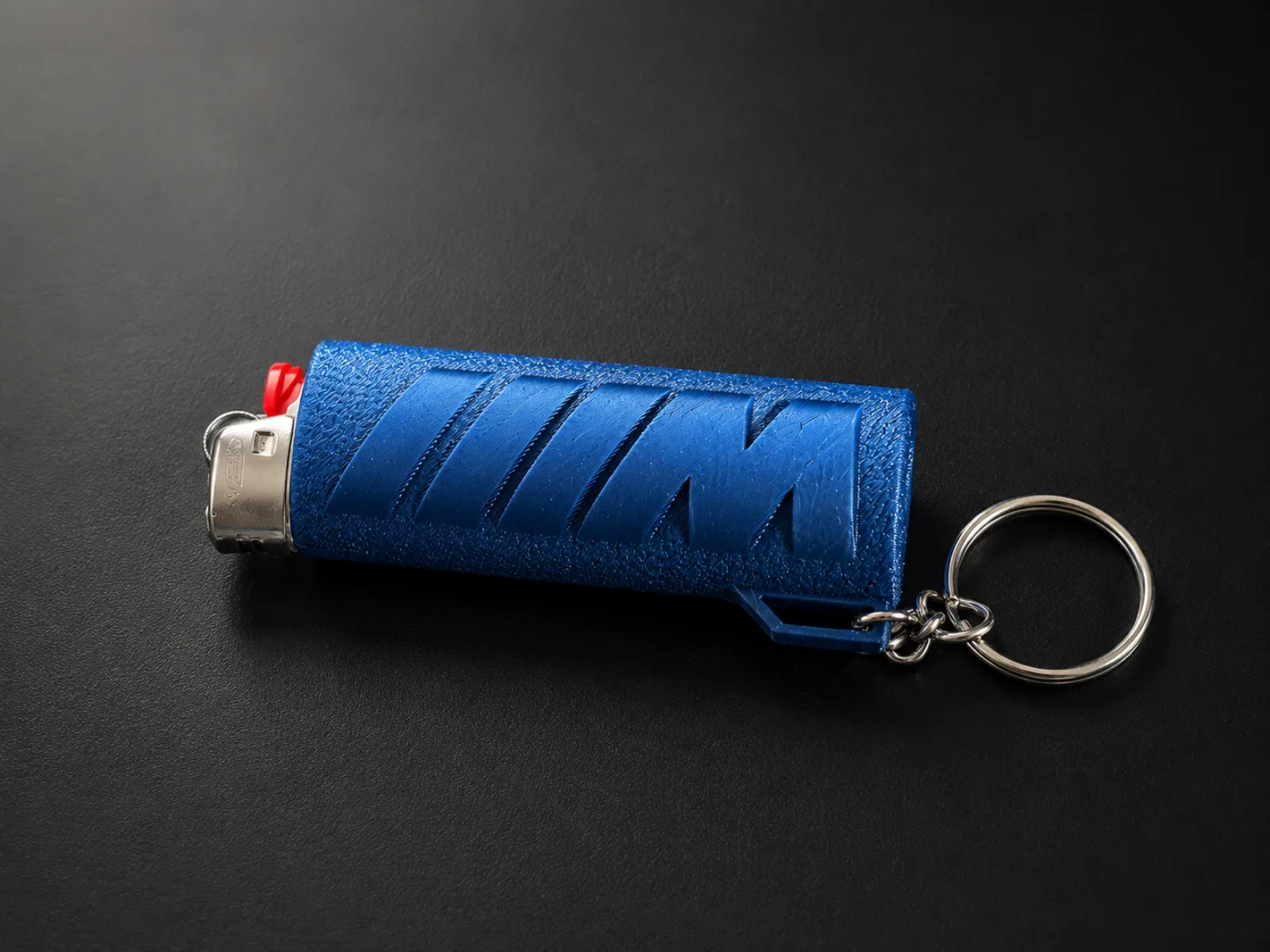 Blue BMW M-style lighter case lying on its side