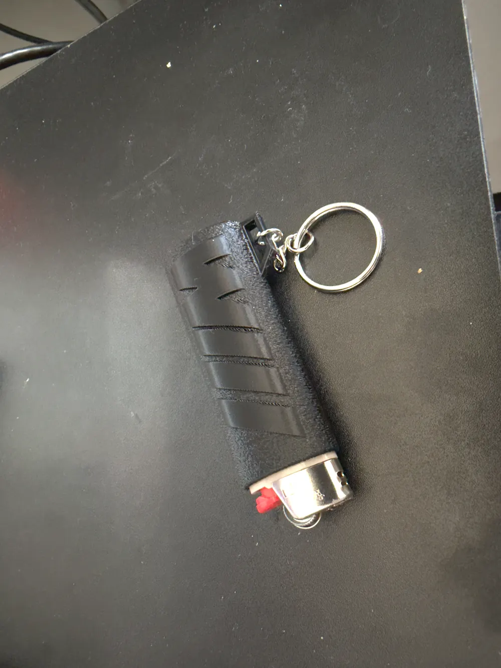 Original phone photo of the black lighter case lying on its side