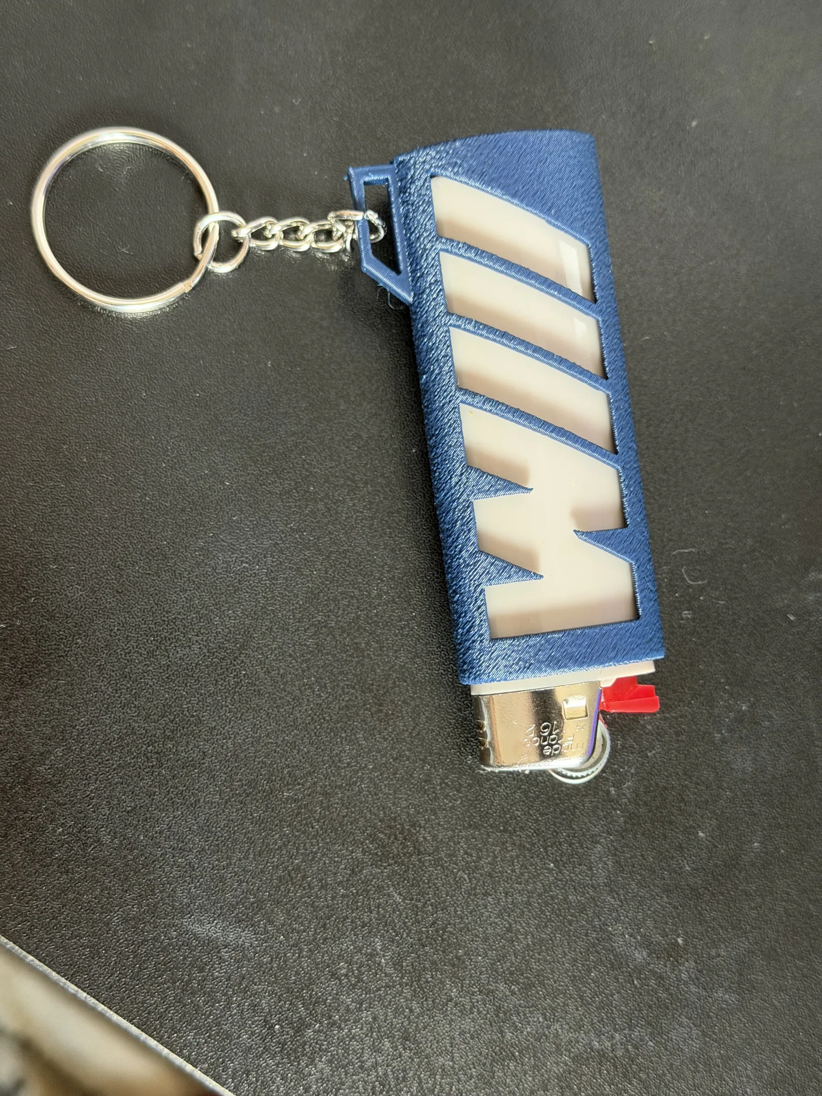 Phone photo documenting the lighter case shape and hand scale