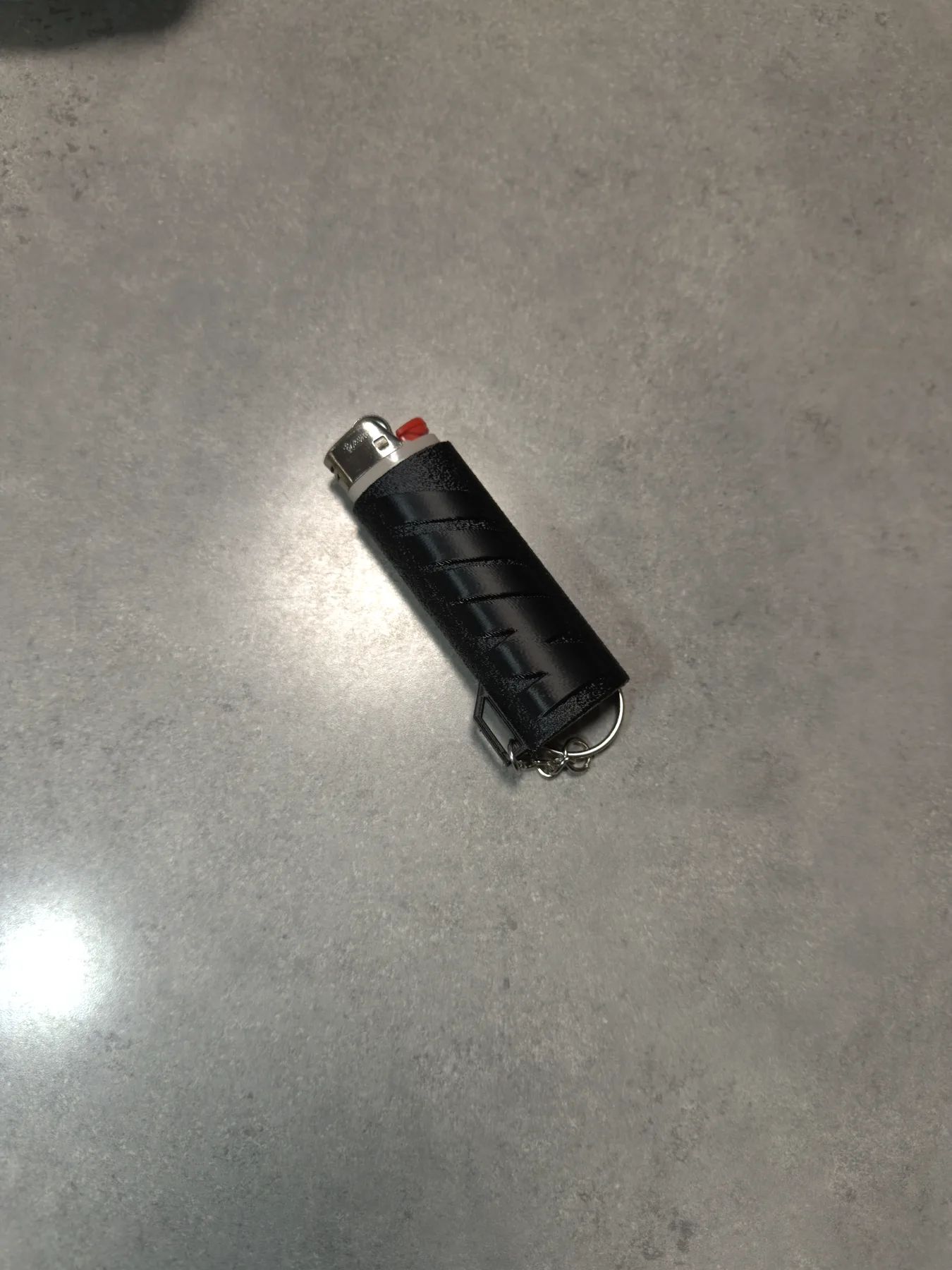 Raw camera reference photo documenting the lighter case shape and scale