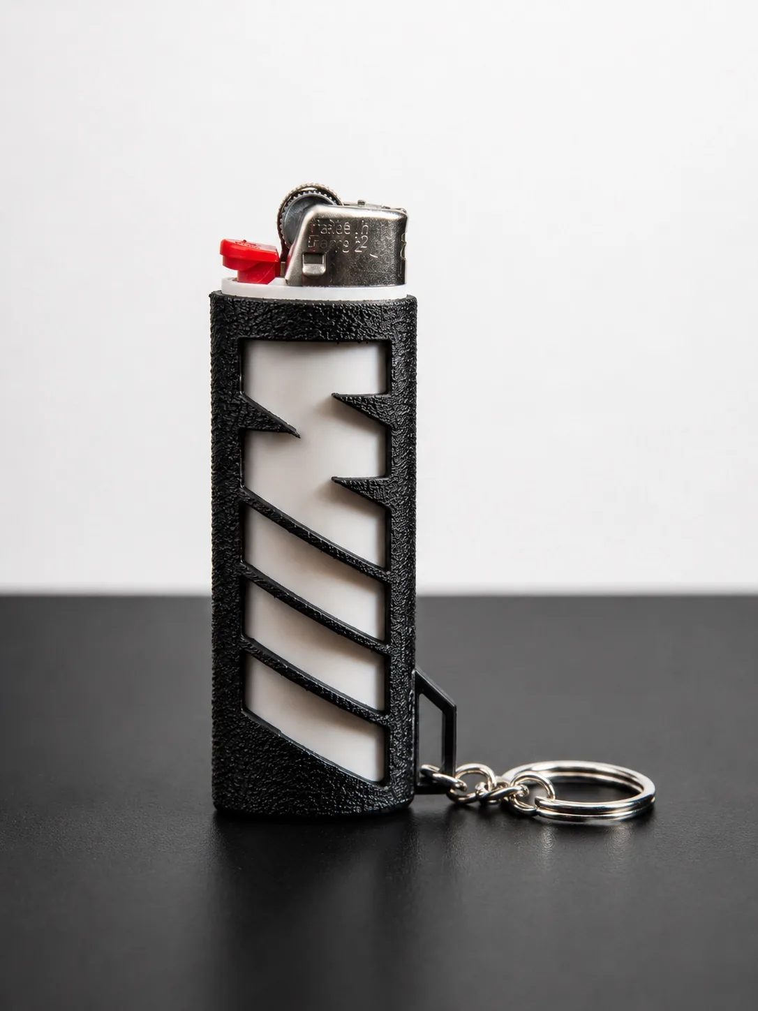 Black M Sport Bic Lighter Key Chain standing upright